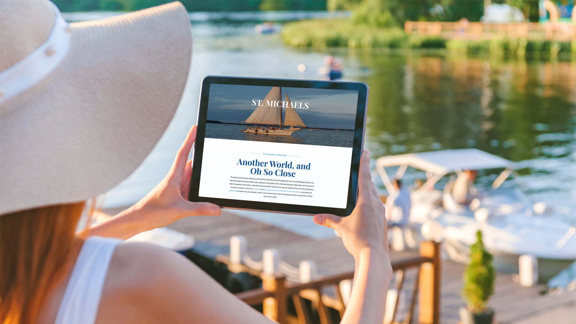 The Talbot County tourism web design being browsed waterside by a local woman on a tablet