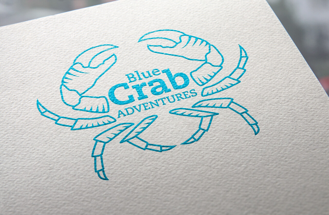 The Blue Crab Adventures logo design printed on paper in vibrant blue ink.