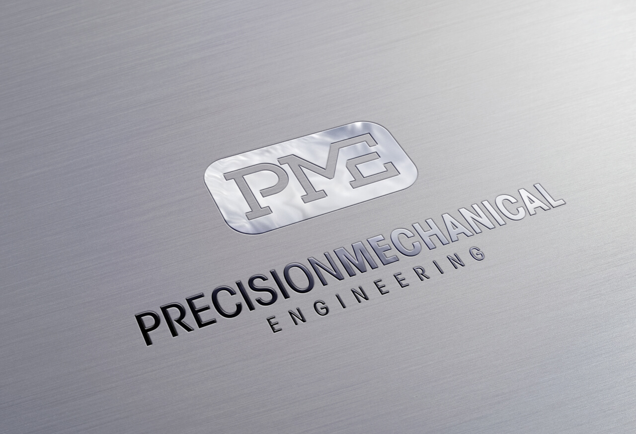 The Precision Mechanical Engineering logo design printed on paper with a metallic shine
